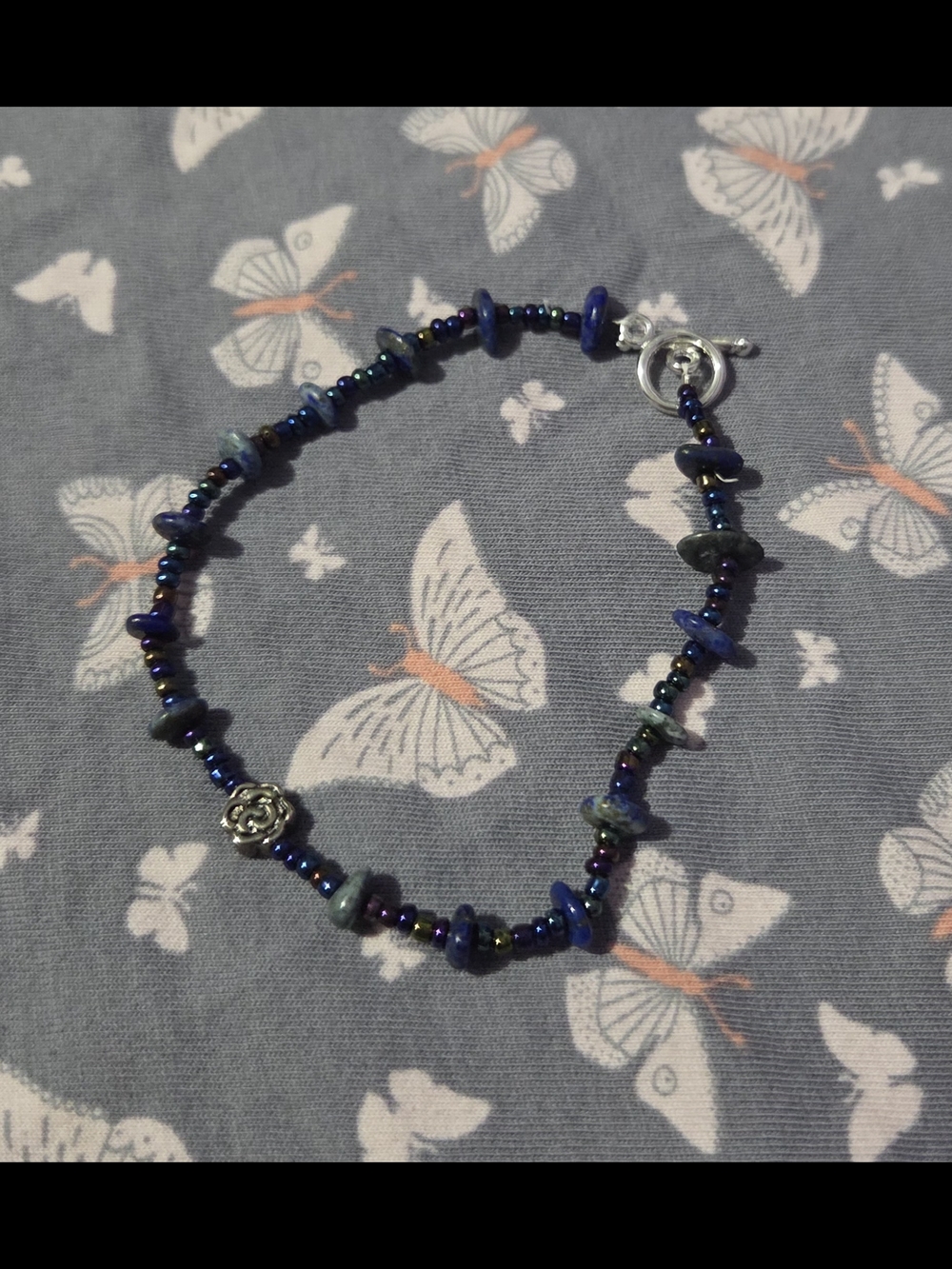 Handcrafted Blue Beaded Women’s Bracelet with Silver Floral Charm